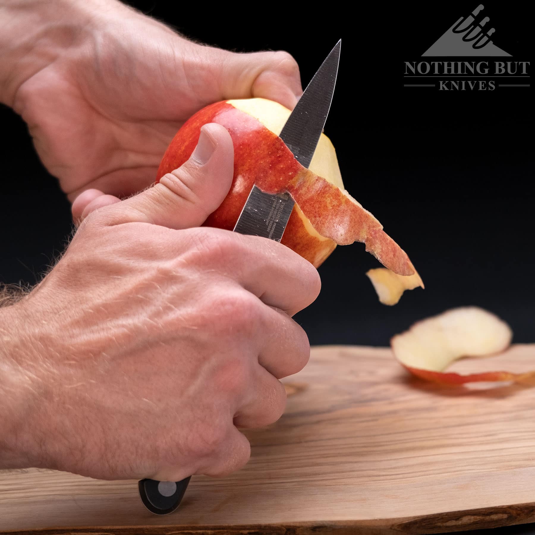 Peeling a red apple with the Zwilling Professional S paring knife.