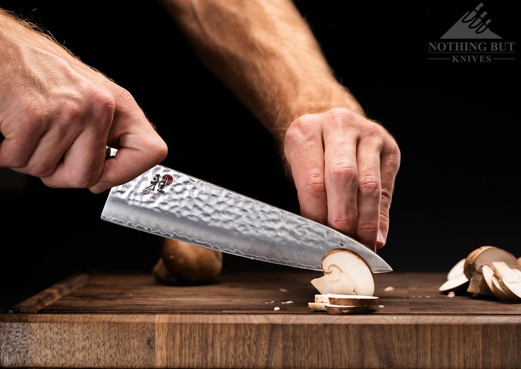The Miyabi Mizu SG2 8 inch chef knife on a wood cutting board.
