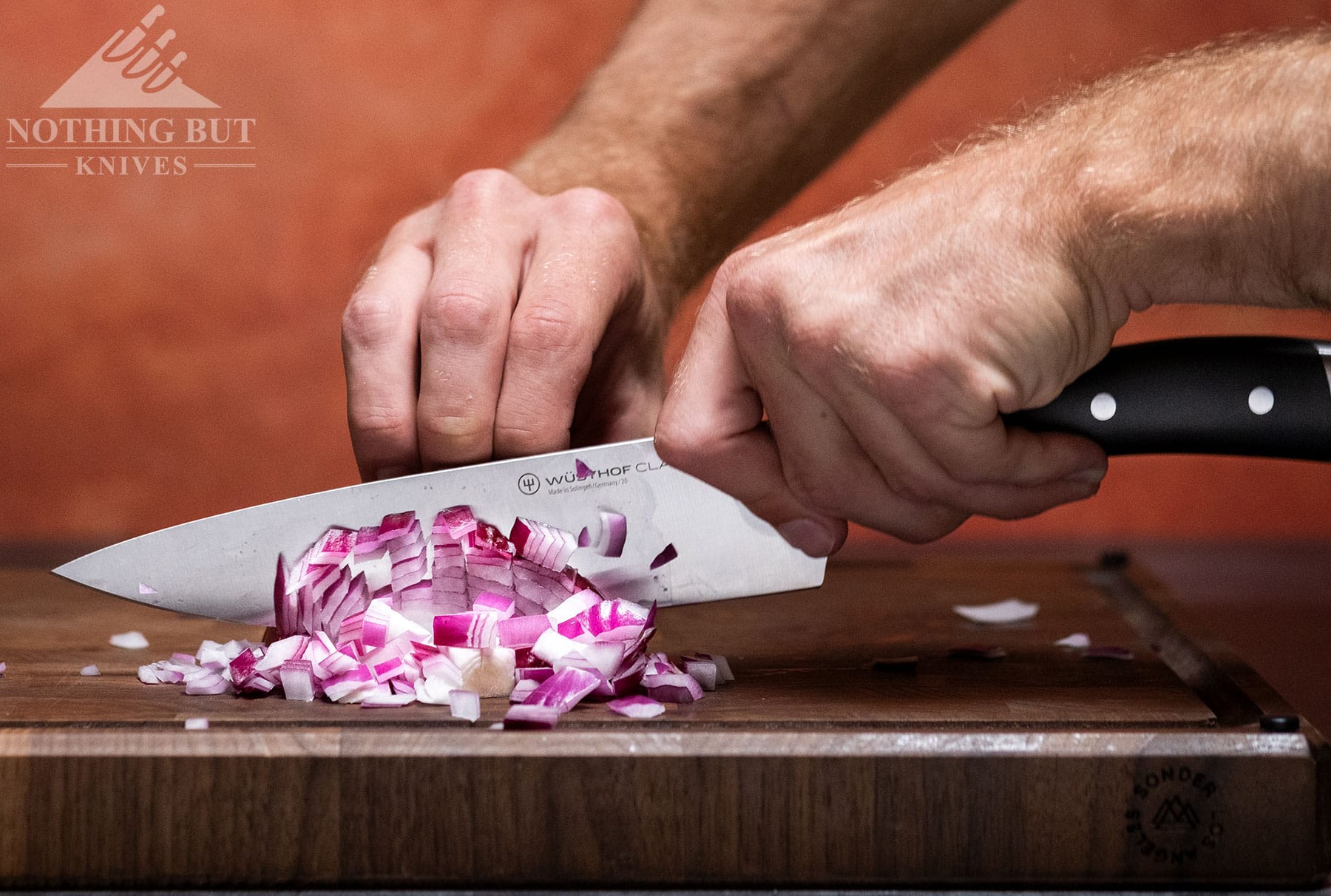 Dicing onions with the Wusthof Classic Ikon Professional chef knife.