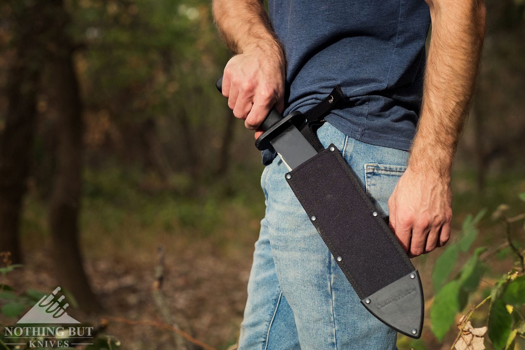 The Black Bear Bowie knife being deployed from its sheath.