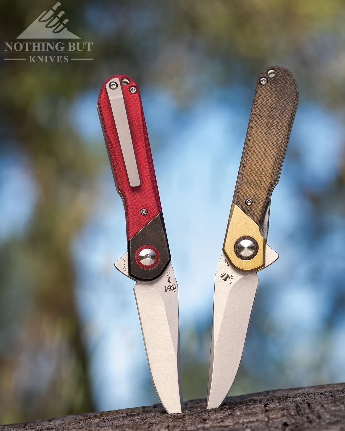 The two different versions of the Kizer Comet on a log in a field. The red Micarta version is on the left and the green Micarta version is on the right. 