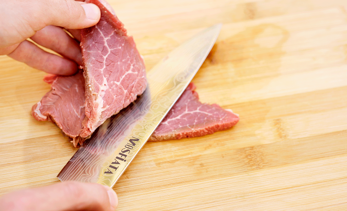 https://www.nothingbutknives.com/wp-content/uploads/2019/09/Mosfiata-Chef-Knife-Slicing-Beef.png