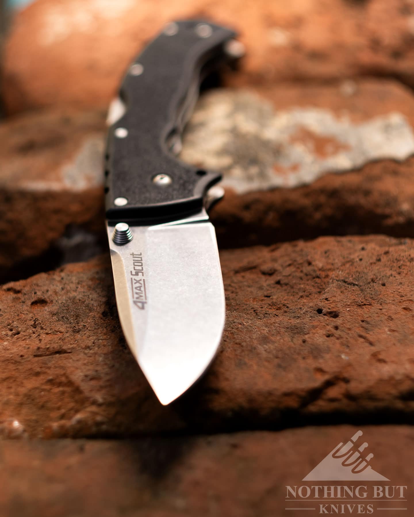 A close-up of the Cold Steel 4-MAX Scout folding knife in the open position with the tip of the blade facing forward.