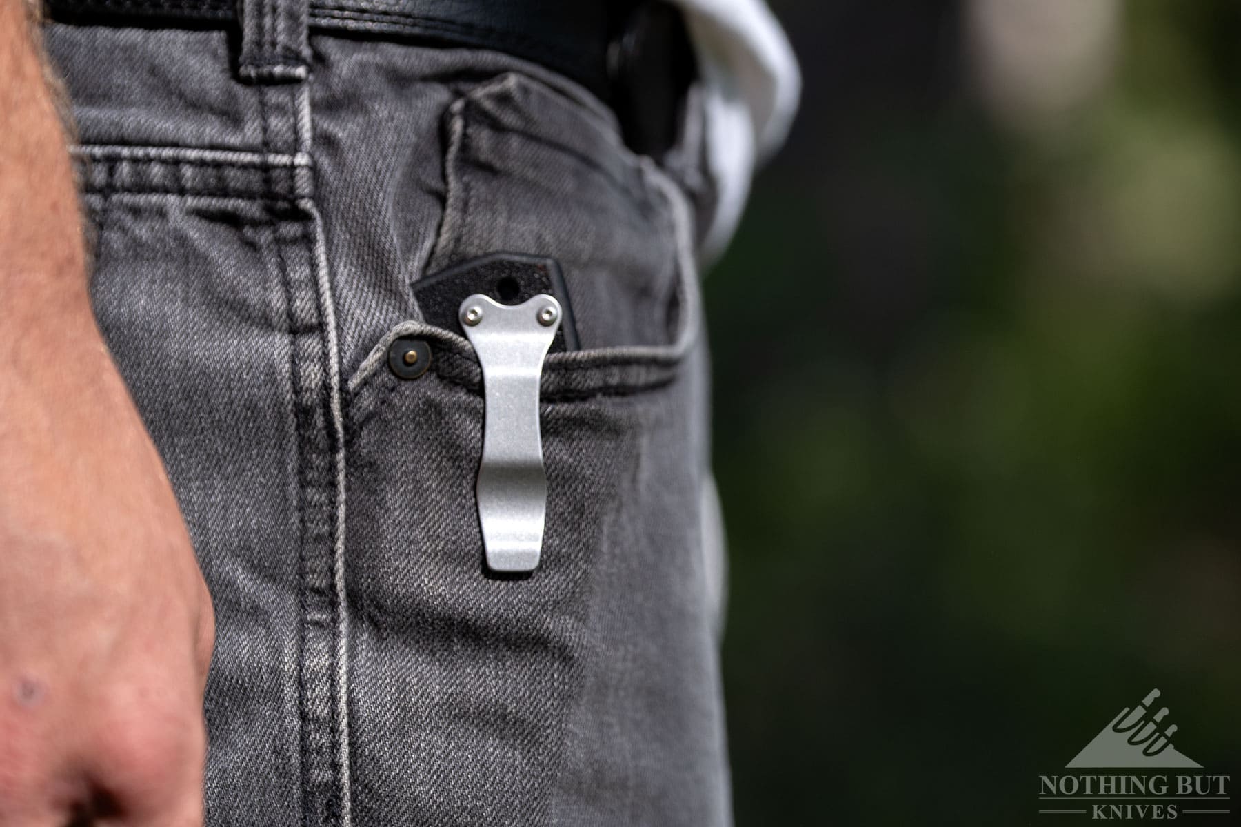 The 4-MAX Scout in the right front pocket of a person's jeans to show how the clip holds.