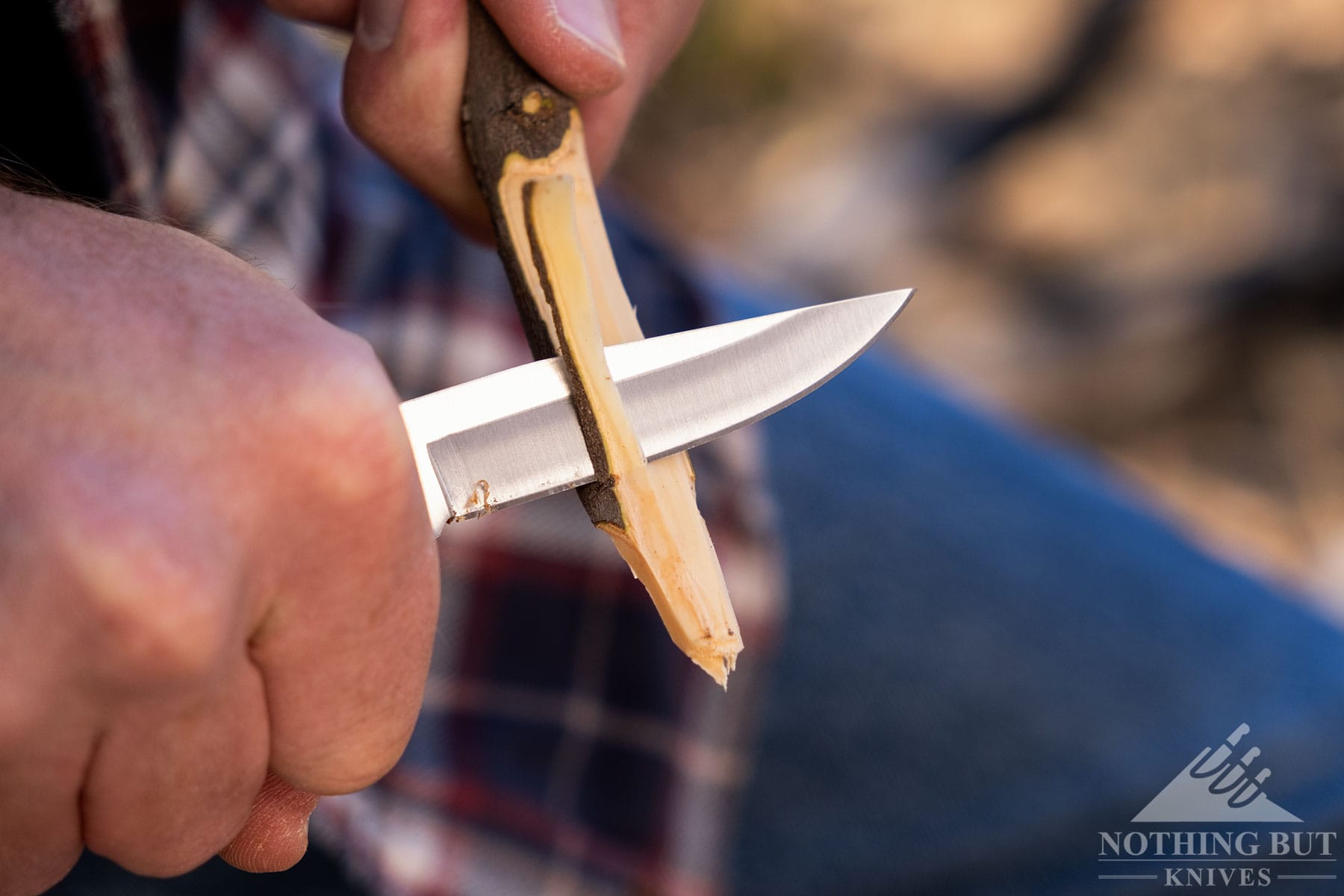 A close-up of the Joker Pointer being used to carve a stick. 