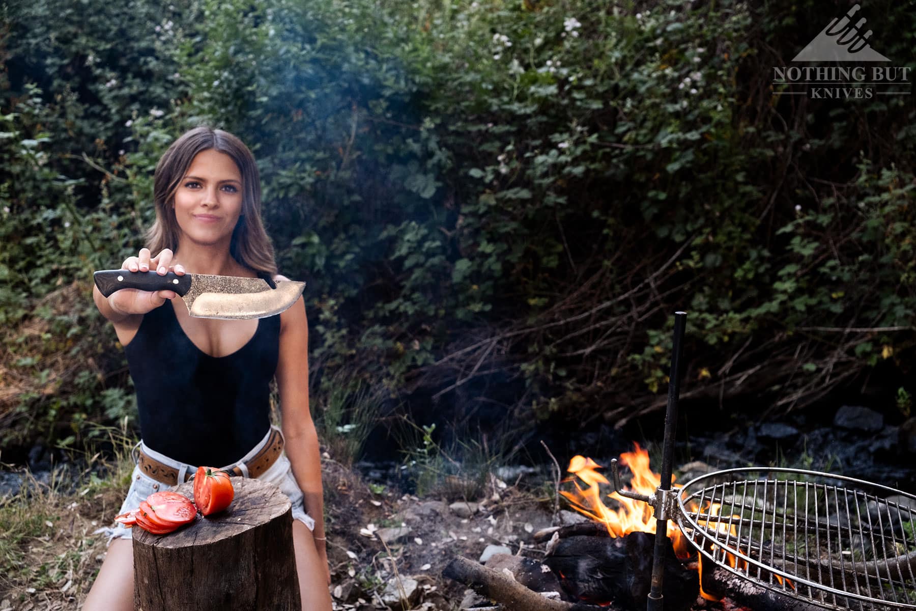 We tested over twenty camp cooking knives and picked the top performing knives for this article. One of our reviewers can be seen here holding the Condor Bush Slicer.