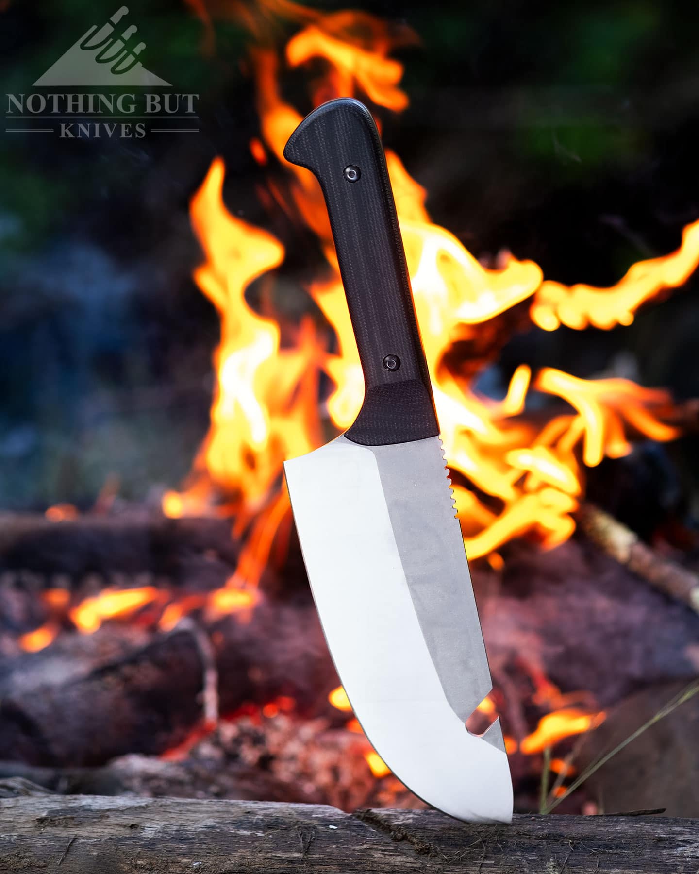 Camping with the Maxsa Blade bushcraft chef knife shown here in front of a campfire. 
