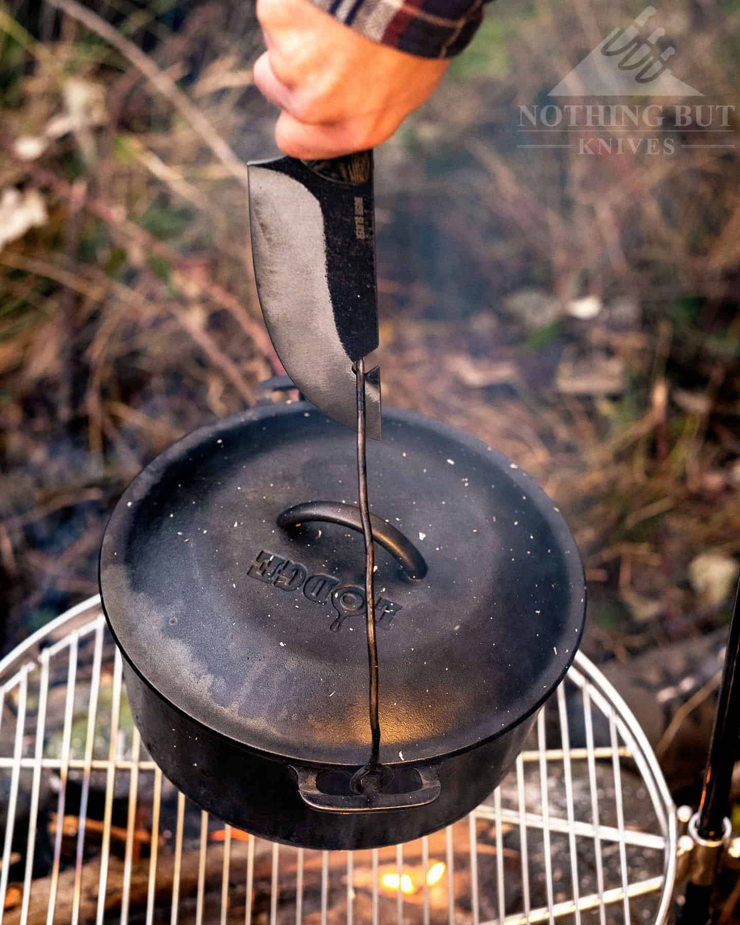 The pot hook on the blade of the COndor Bush Slicer is a good way to avoid burning your hands when taking a kettle of the campfire.