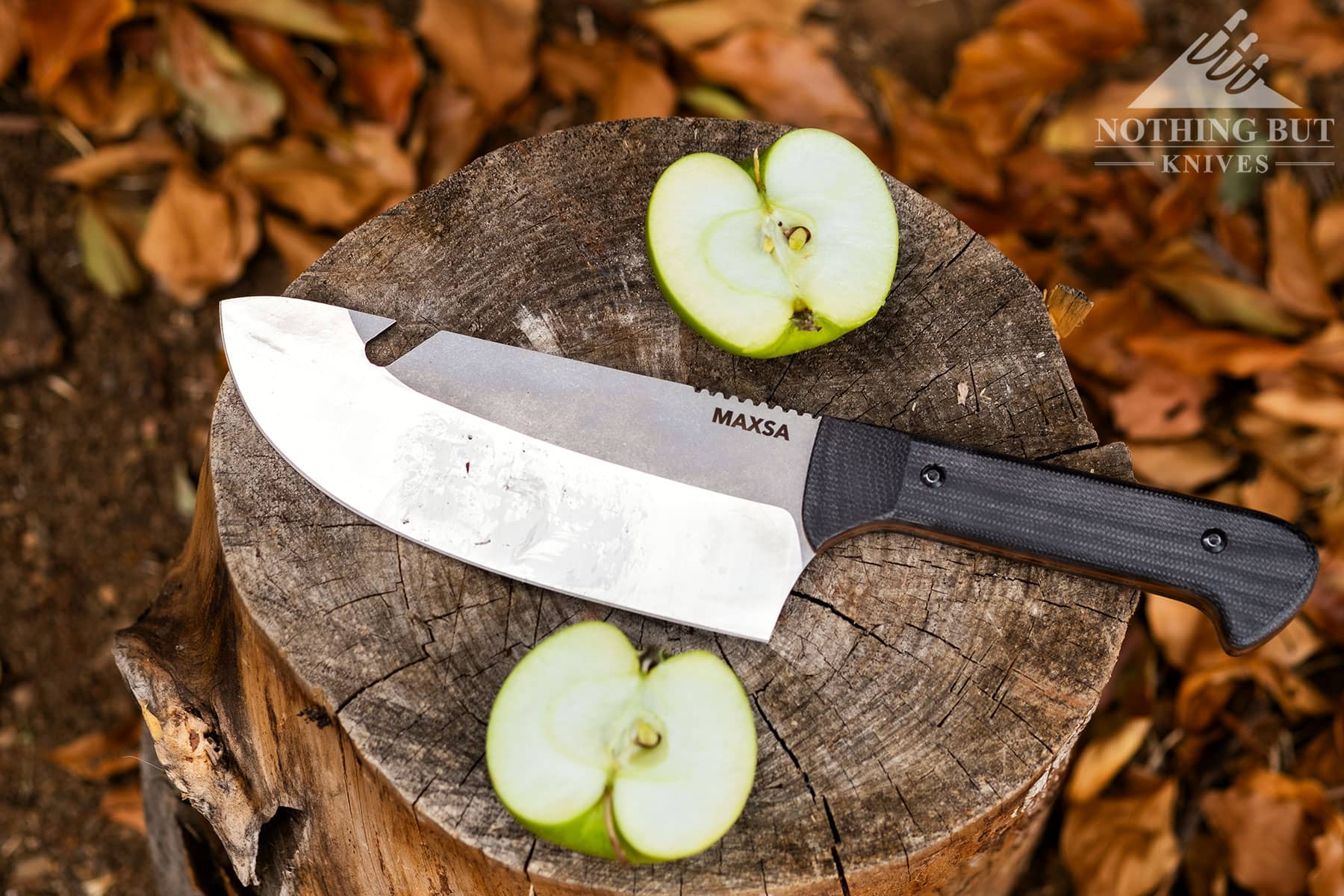 The Maxsa camping chef knife between two haves of an apple it was used to slice.
