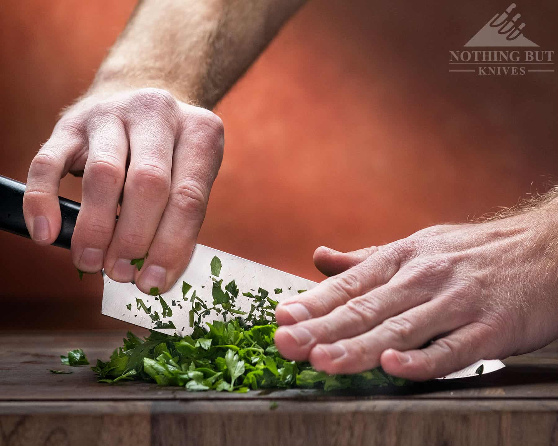 https://www.nothingbutknives.com/wp-content/uploads/2023/01/Dicing-Herbs-with-the-Artisan-Chef-Knife.jpg