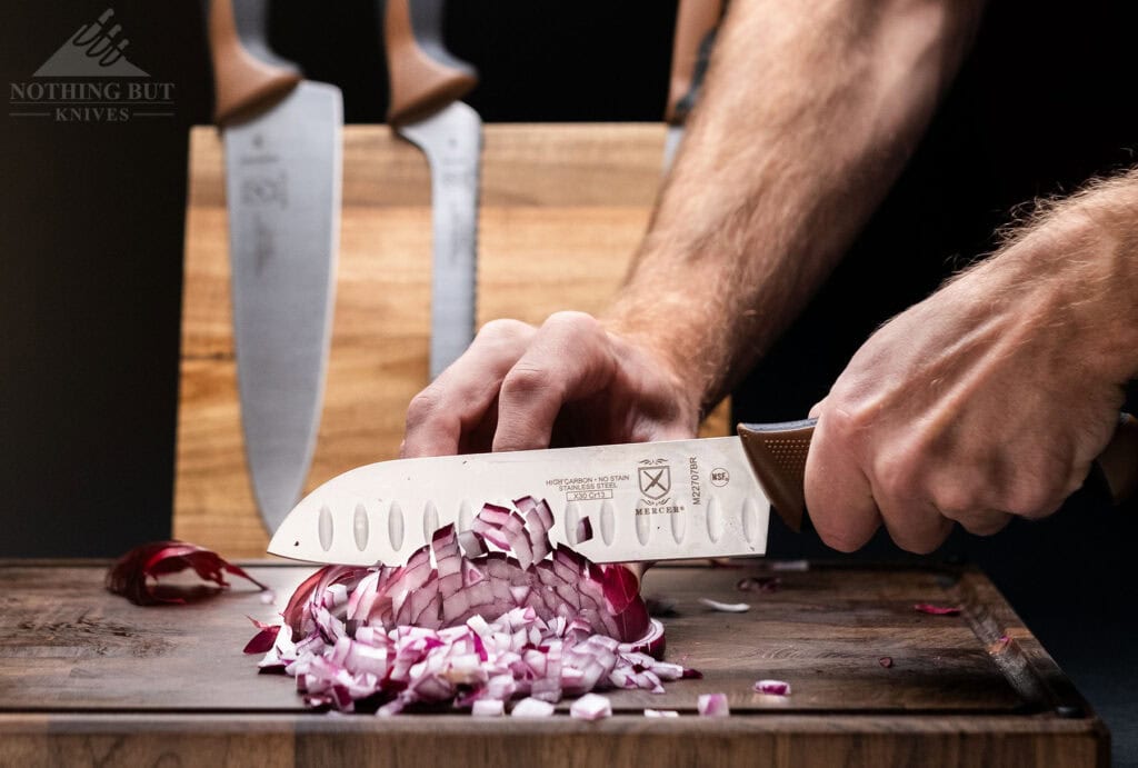 The Mercer Millennia santoku knife dicing a red onion.