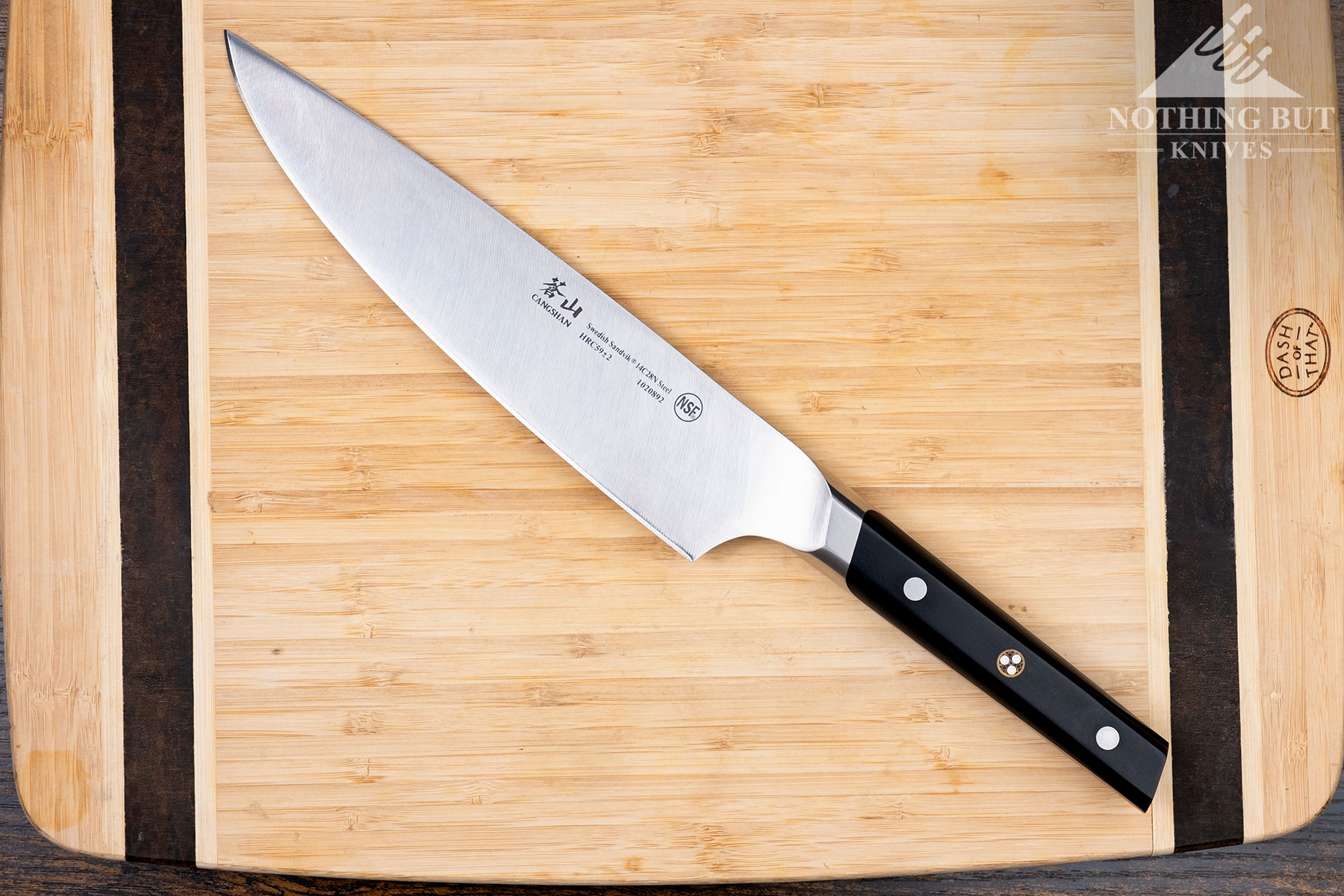 The Cangshan TC 8 inch chef knife on a bamboo cutting board. 