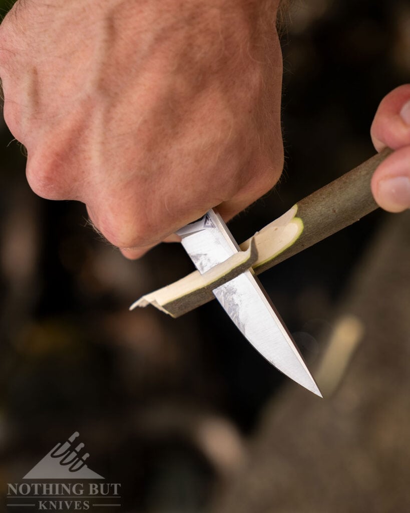 The Begg Knives Diamici folding knife carving a stick.