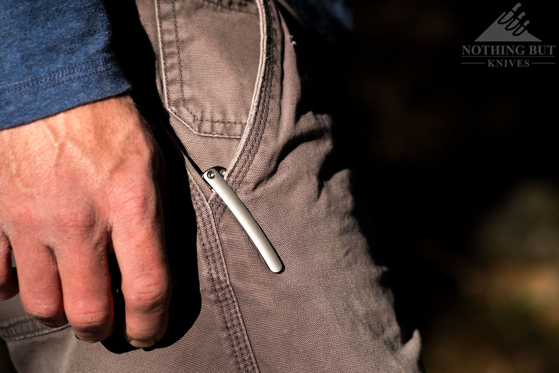 The titanium pocket clip rests easy in a pair of gray jeans.