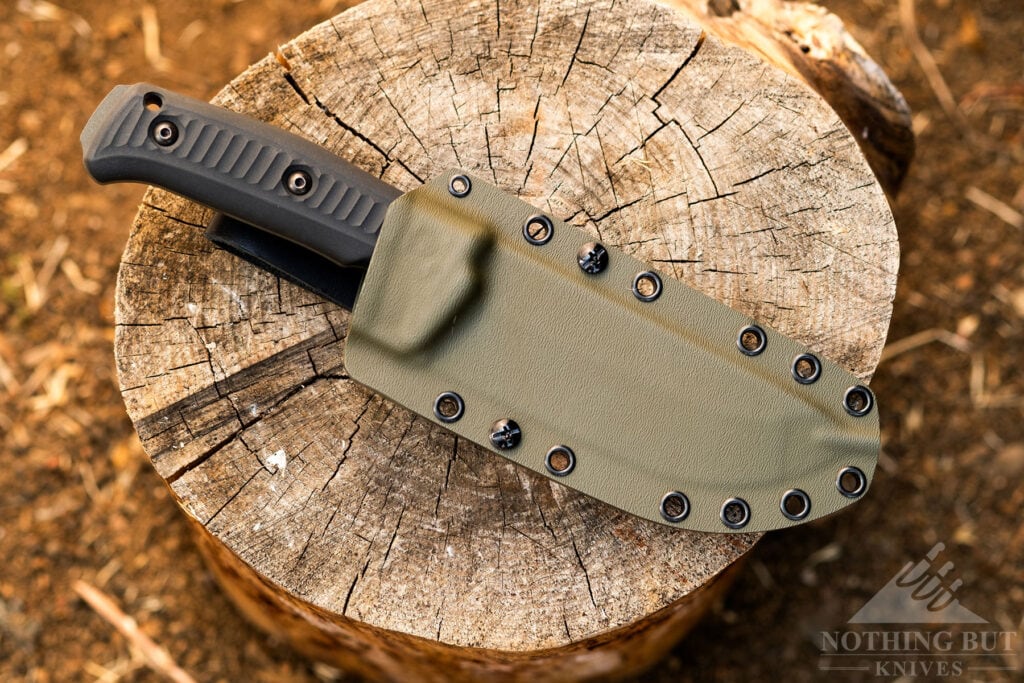 The Schwarz Lost Trail 5 fixed blade camp knife shown inside its OD green sheath.