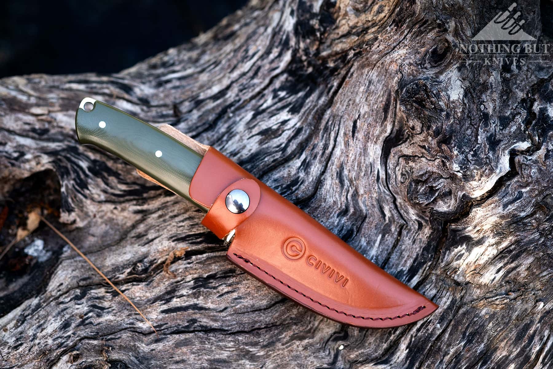 An overhead view of the Civivi Cloud Peak knife inside its brown leather sheath.