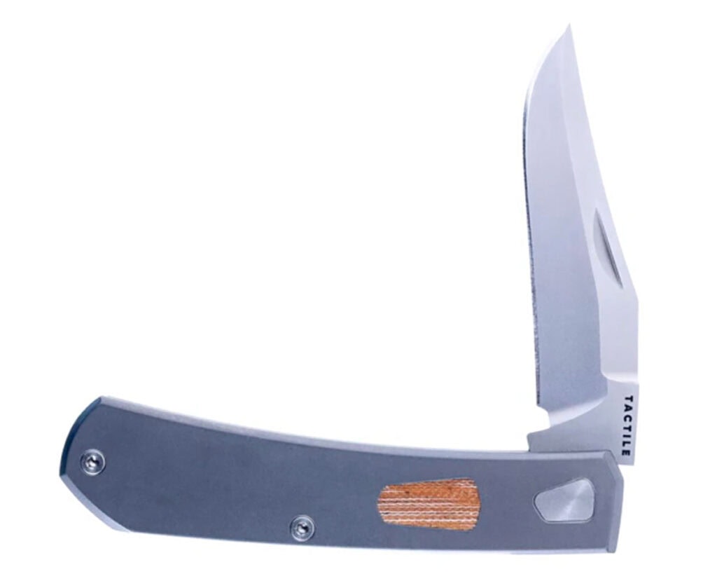 The Tactile Knife Co Ranger Slip Joint knife with the blade in the half open position in front of a white background.