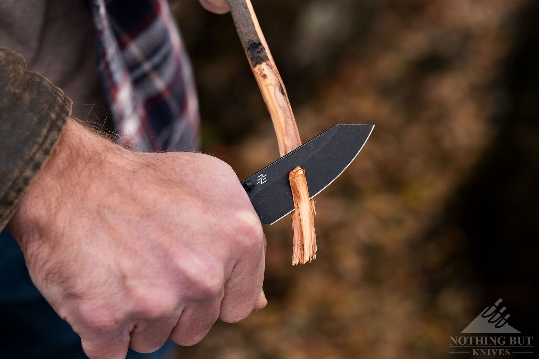 An overhead view of the4 Civivi Yonder knife being used to carve a stick.