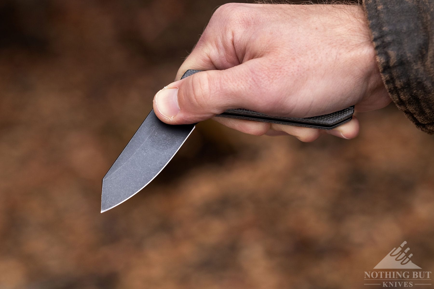 An overhead shot of the Civivi Yonder's blade being opened with a person's right hand. 