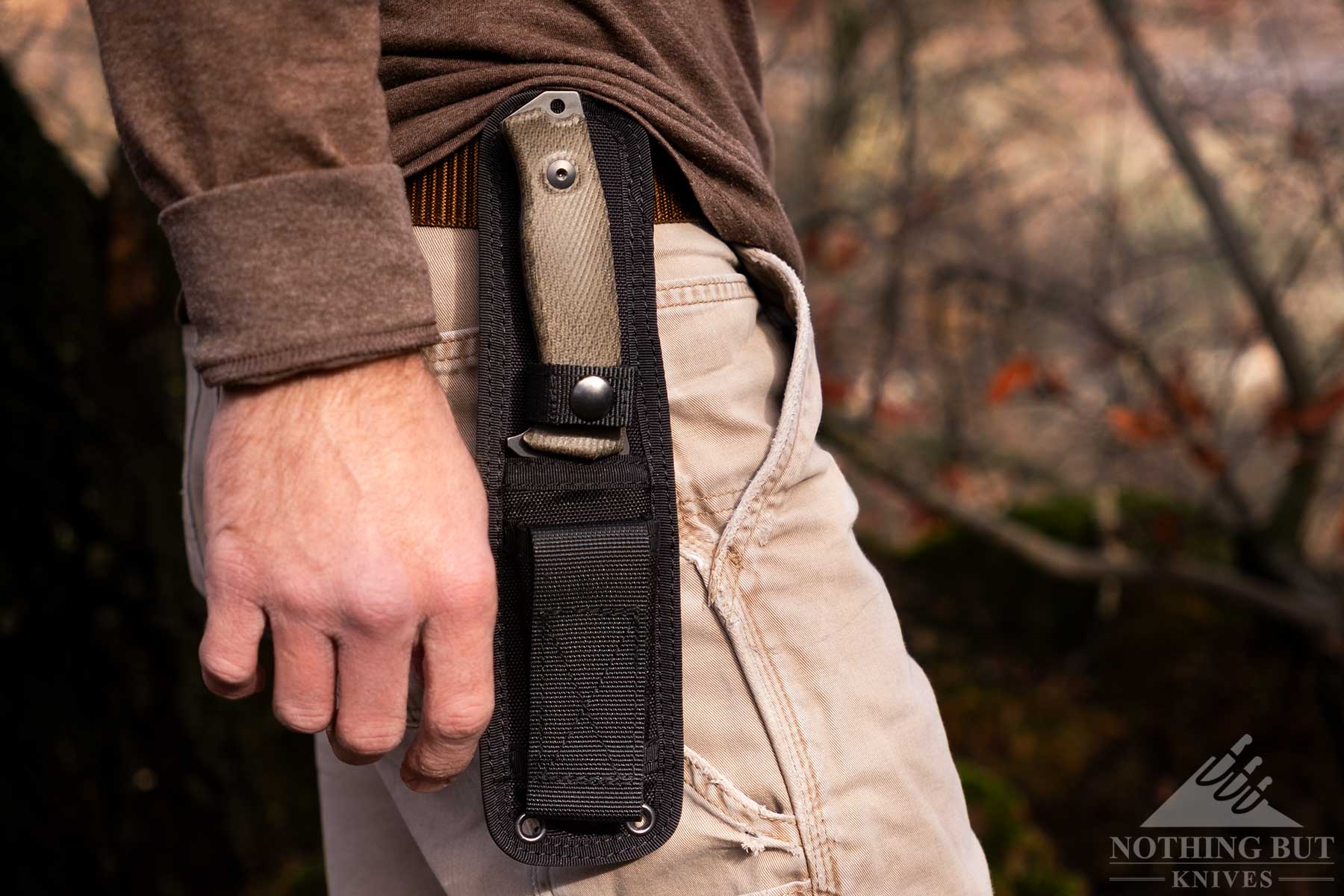 The Corura version of the LionSteel M5 being worn on a leather belt on the right side of a person's hip. 