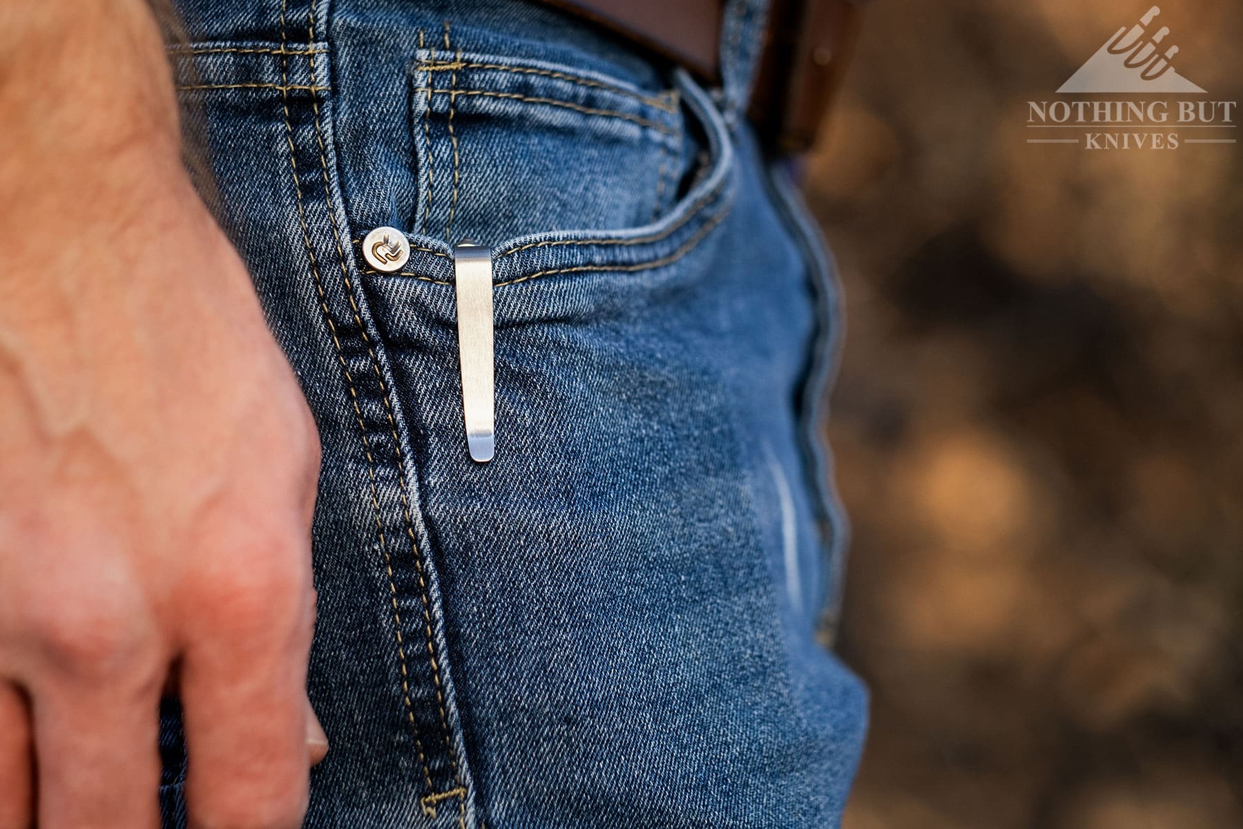 The LionSteel SR22 pocket clip attached to the right front pocket of a person's jeans. 