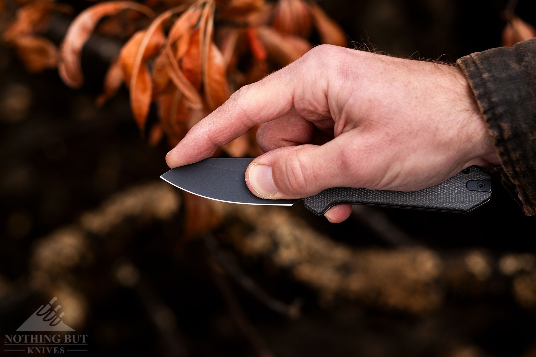 A close-up of the Civivi Yonder folding knife being held in a person's right hand using a modified pinch grip.