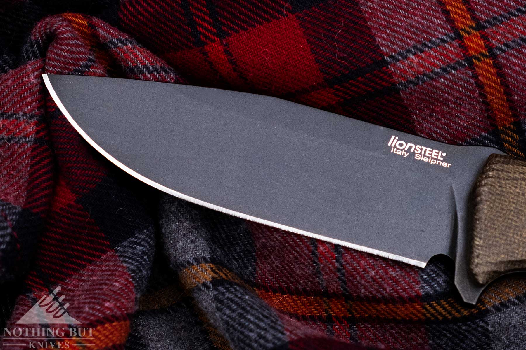 An overhead view of the LionSteel M5 blade on top of a flannel shirt.