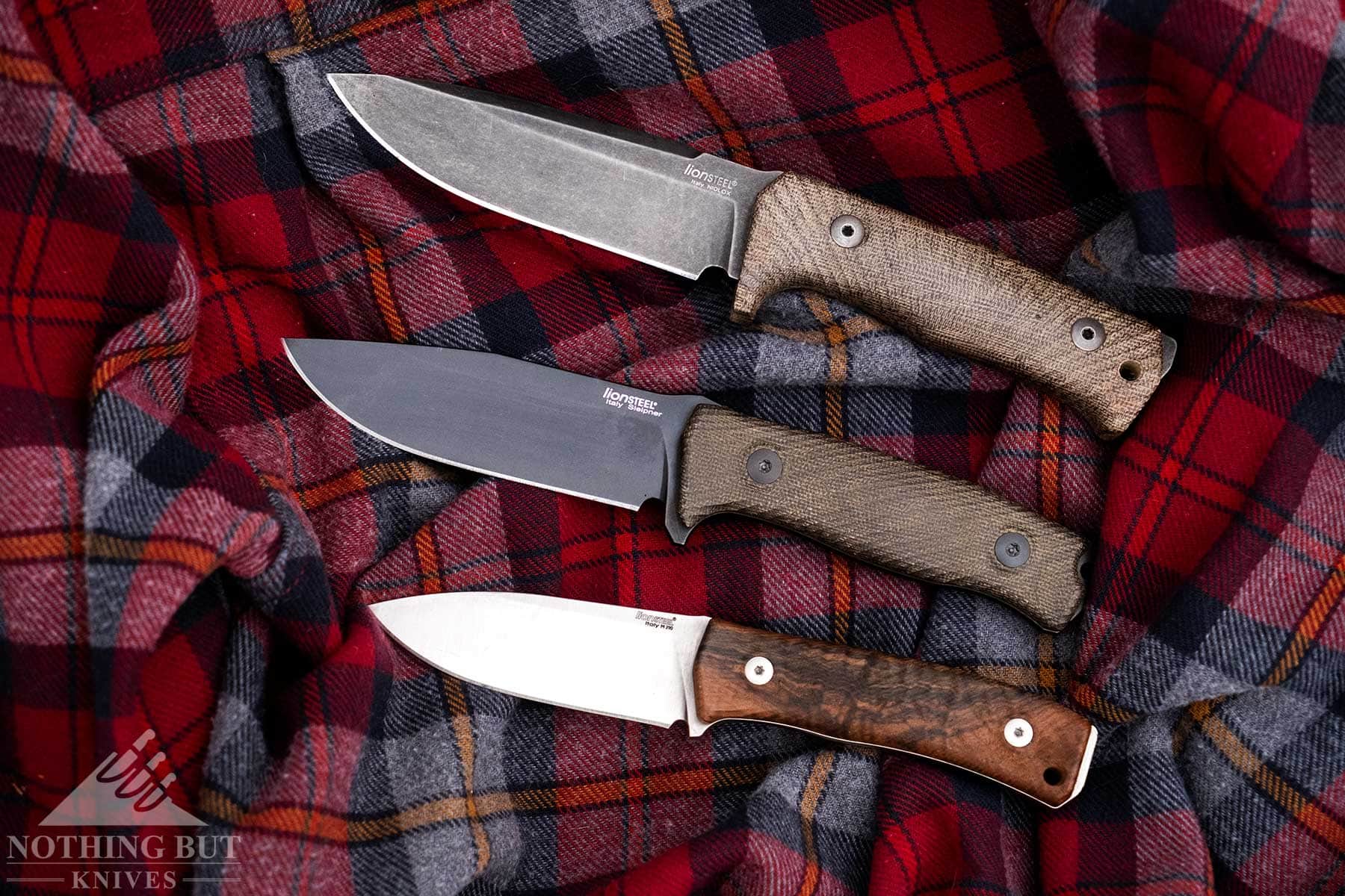 An overhead view of the LionSteel M5 shown here with the T5 and M4 on a flannel shirt.